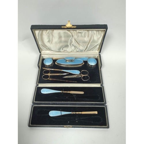 79 - Silver hairbrush and mirror with guilloche enamel, 1936 and a similar manicure set, both cased.