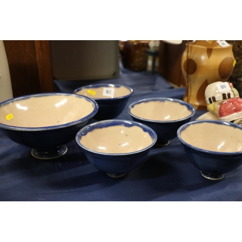 82 - Studio Pottery blue glazed footed bowl, and four smaller matching bowls.  (5)