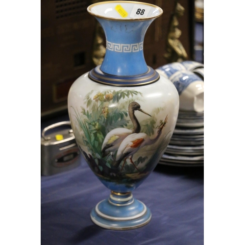 88 - Victorian glass vase decorated with hand-painted scene depicting cranes, 36cm.