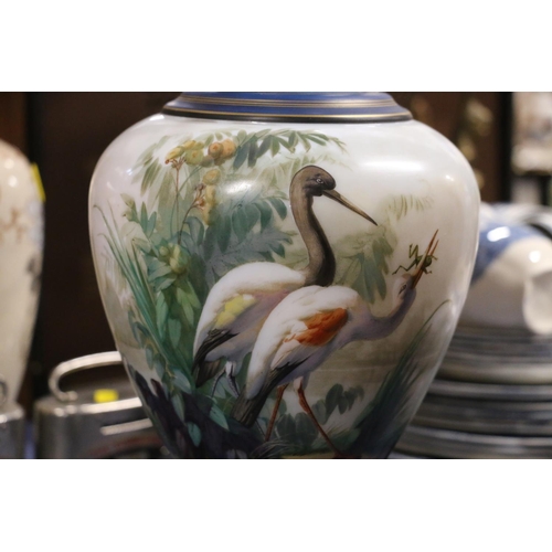 88 - Victorian glass vase decorated with hand-painted scene depicting cranes, 36cm.