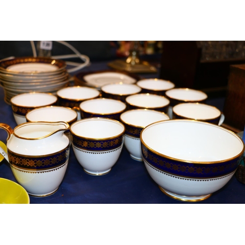 124 - Roslyn China teaset decorated with blue and gilt rim.