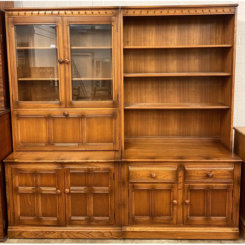 540 - Ercol elm drinks cabinet; together with matching open bookcase; each with two doors on plinth base; ... 