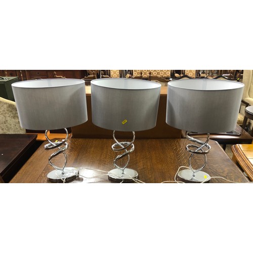 547 - Three contemporary chrome table lamps with silver shades