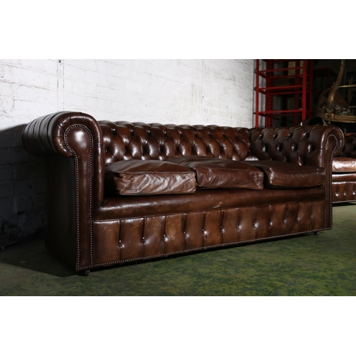 588 - Pair of brown leather button-back three-seater Chesterfield sofas, 196cm long.