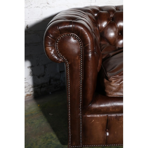 588 - Pair of brown leather button-back three-seater Chesterfield sofas, 196cm long.