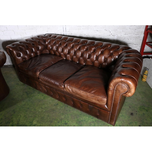 588 - Pair of brown leather button-back three-seater Chesterfield sofas, 196cm long.