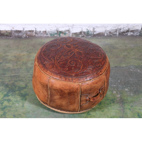 589 - Moroccan tooled leather circular pouffe, the top decorated with scrolling foliate sprays, 45cm diame... 