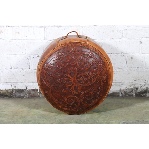 589 - Moroccan tooled leather circular pouffe, the top decorated with scrolling foliate sprays, 45cm diame... 