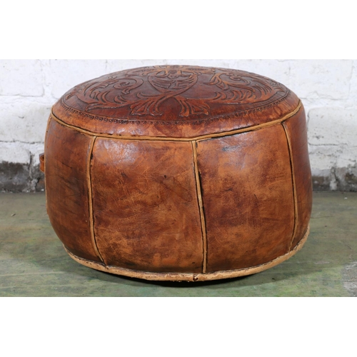 589 - Moroccan tooled leather circular pouffe, the top decorated with scrolling foliate sprays, 45cm diame... 