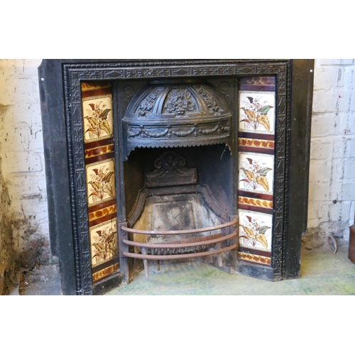 592 - A Victorian cast iron fire surround, with foliate decorated dome hood over fire basket flanked by li... 