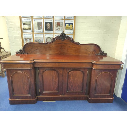 607 - Victorian mahogany reverse breakfront sideboard, foliate scroll raised back above frieze drawers and... 