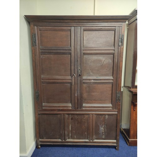 611 - Antique oak cupboard, moulded pediment above pair of triple panel doors on panelled box base and sti... 