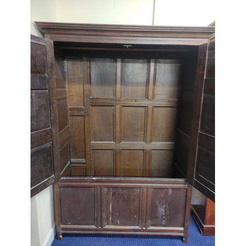 611 - Antique oak cupboard, moulded pediment above pair of triple panel doors on panelled box base and sti... 