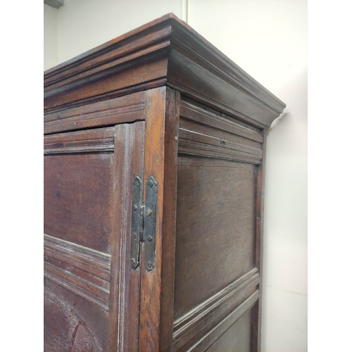 611 - Antique oak cupboard, moulded pediment above pair of triple panel doors on panelled box base and sti... 