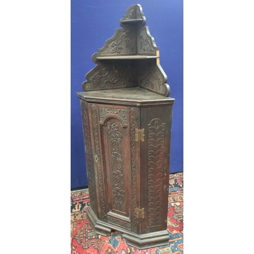 620 - Antique carved oak low standing corner cupboard with tiered shelves above, on ogee bracket feet, 150... 