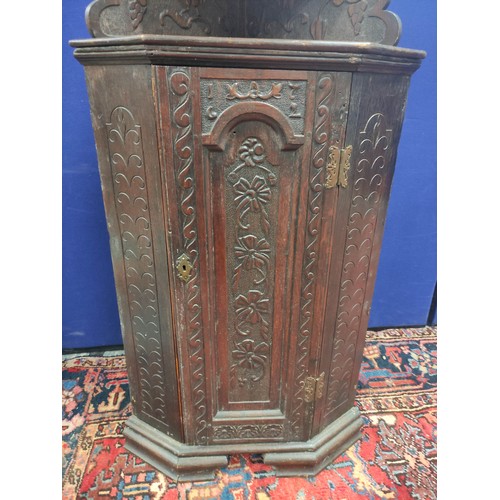 620 - Antique carved oak low standing corner cupboard with tiered shelves above, on ogee bracket feet, 150... 