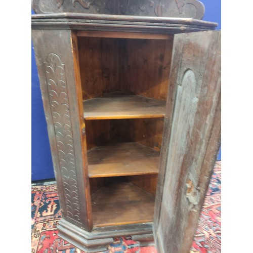 620 - Antique carved oak low standing corner cupboard with tiered shelves above, on ogee bracket feet, 150... 