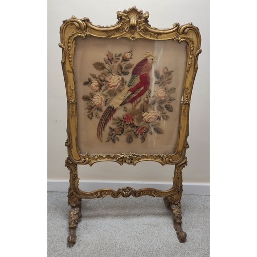 621 - Ornate 19th century firescreen, the foliate scroll gilt frame enclosing a cushioned tapestry depicti... 