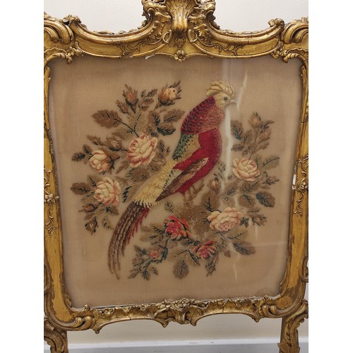 621 - Ornate 19th century firescreen, the foliate scroll gilt frame enclosing a cushioned tapestry depicti... 