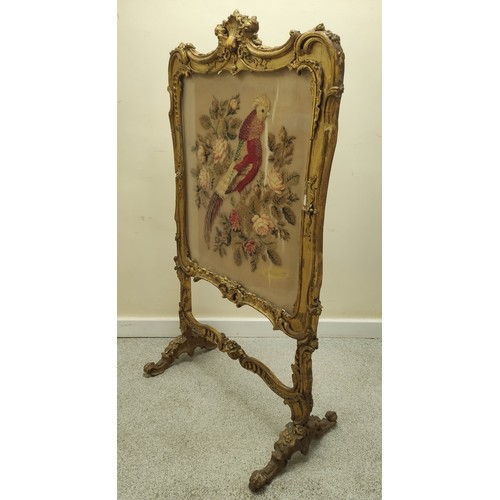 621 - Ornate 19th century firescreen, the foliate scroll gilt frame enclosing a cushioned tapestry depicti... 