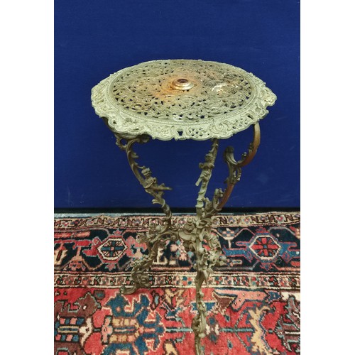 628 - Foliate pierced brass circular occasional table on foliate scroll supports with climbing cherubs, 45... 