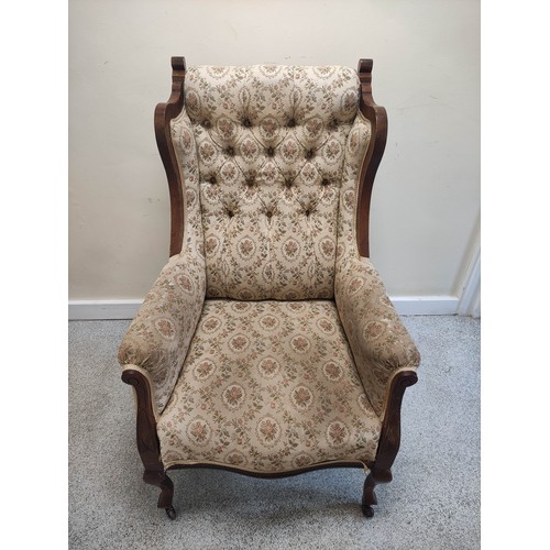 636 - Edwardian walnut framed wing armchair with button back and show-wood side rails and arm terminals on... 