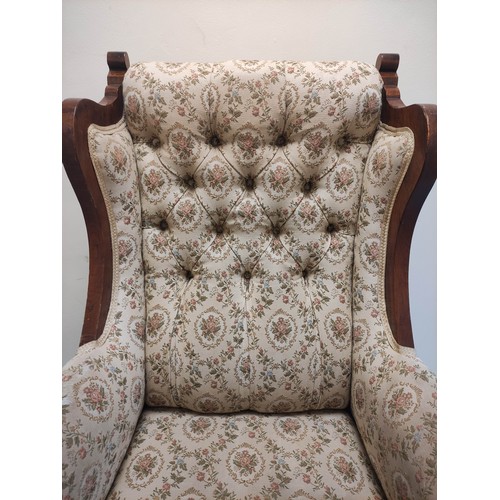 636 - Edwardian walnut framed wing armchair with button back and show-wood side rails and arm terminals on... 