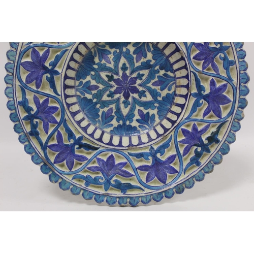 257 - Antique Islamic Isnik or Persian circular pottery charger or rosewater dish decorated with central s... 