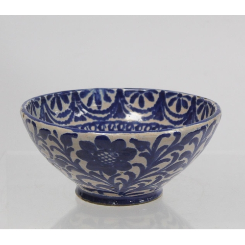 259 - Middle Eastern small earthenware blue and white circular bowl decorated with stylised flowers and fo... 