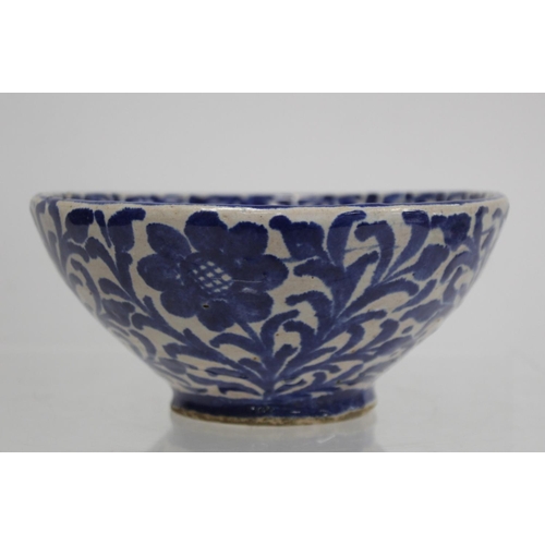 259 - Middle Eastern small earthenware blue and white circular bowl decorated with stylised flowers and fo... 