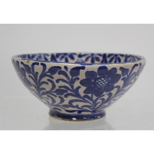 259 - Middle Eastern small earthenware blue and white circular bowl decorated with stylised flowers and fo... 