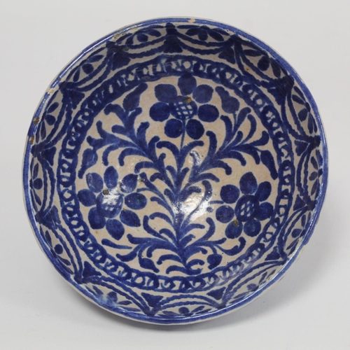 259 - Middle Eastern small earthenware blue and white circular bowl decorated with stylised flowers and fo... 