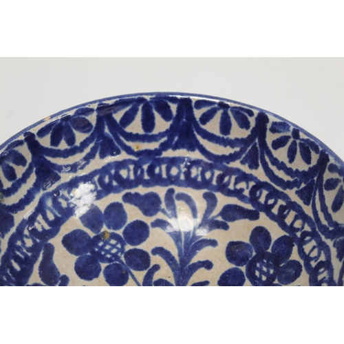 259 - Middle Eastern small earthenware blue and white circular bowl decorated with stylised flowers and fo... 