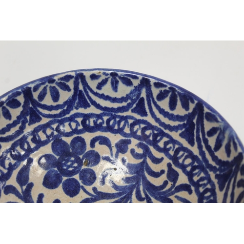 259 - Middle Eastern small earthenware blue and white circular bowl decorated with stylised flowers and fo... 