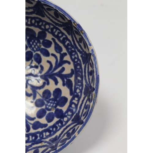 259 - Middle Eastern small earthenware blue and white circular bowl decorated with stylised flowers and fo... 