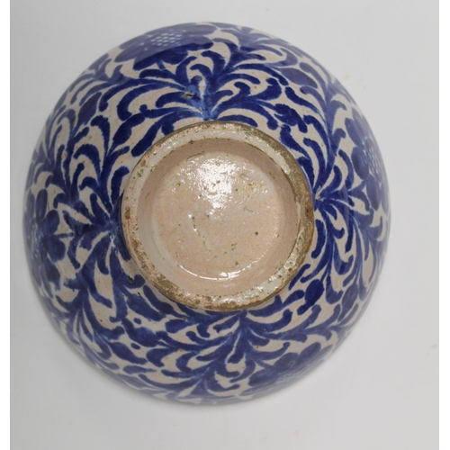 259 - Middle Eastern small earthenware blue and white circular bowl decorated with stylised flowers and fo... 