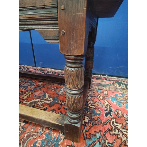 651 - Antique oak refectory table in the 17th century style with cleated triple plank top on foliate and r... 