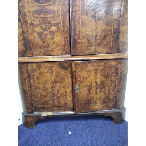 652 - 18th century North European figured walnut dome top standing corner cupboard, the moulded pediment a... 