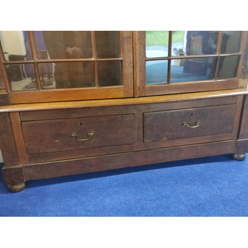 583 - Oak cabinet bookcase, c.1890's, the upper section with moulded pediment above glazed astragal doors ... 