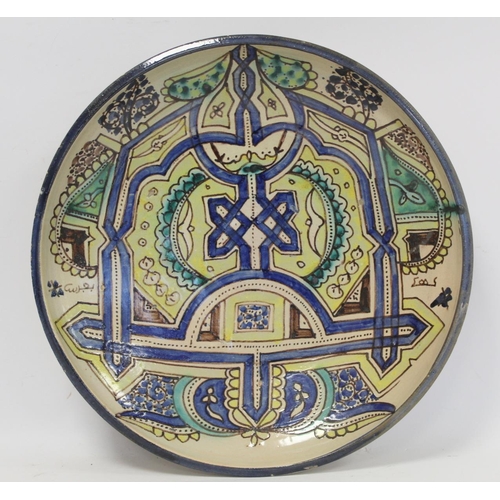 191 - Large Islamic earthenware charger of circular form with geometric and stylised foliate decoration in... 