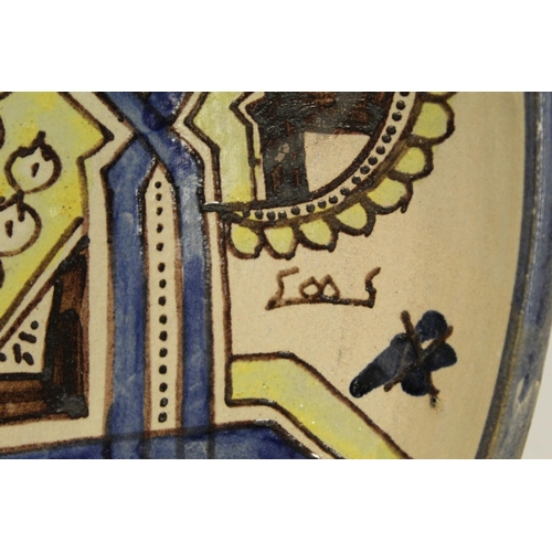 191 - Large Islamic earthenware charger of circular form with geometric and stylised foliate decoration in... 