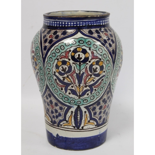 192 - Islamic Iznik style tin glazed earthenware vase of baluster form, probably Moroccan, with four circu... 