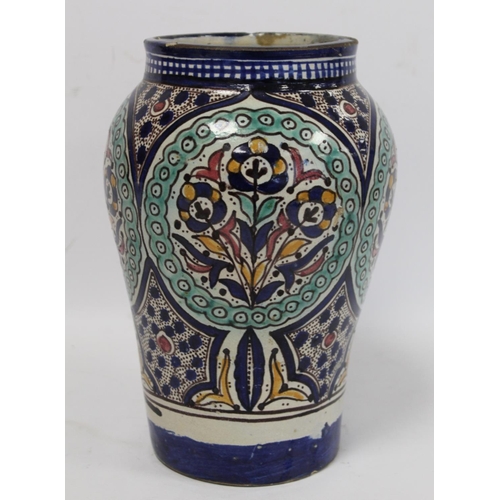 192 - Islamic Iznik style tin glazed earthenware vase of baluster form, probably Moroccan, with four circu... 