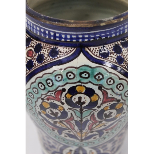 192 - Islamic Iznik style tin glazed earthenware vase of baluster form, probably Moroccan, with four circu... 