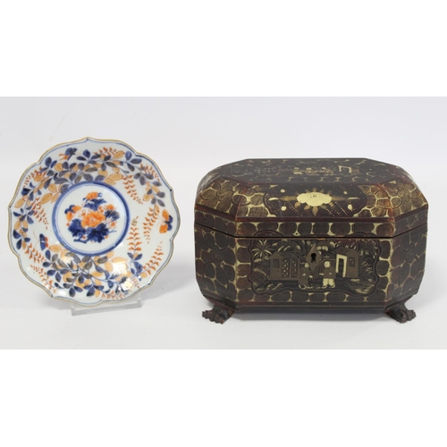 287 - 19th century Chinese black lacquer tea caddy of octagonal form with four paw feet and gilt painted p... 