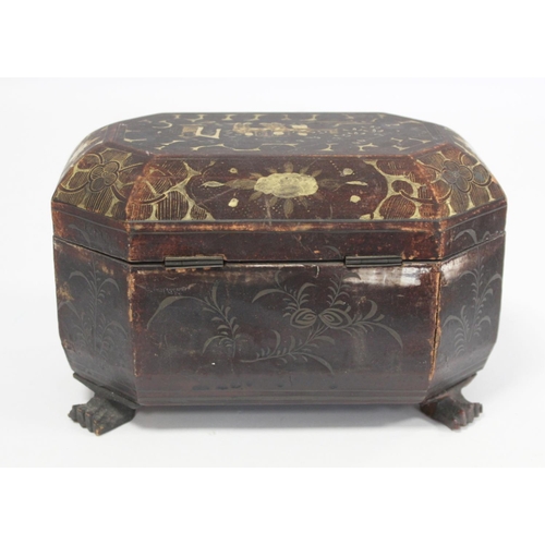 287 - 19th century Chinese black lacquer tea caddy of octagonal form with four paw feet and gilt painted p... 