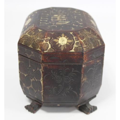 287 - 19th century Chinese black lacquer tea caddy of octagonal form with four paw feet and gilt painted p... 