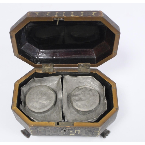 287 - 19th century Chinese black lacquer tea caddy of octagonal form with four paw feet and gilt painted p... 