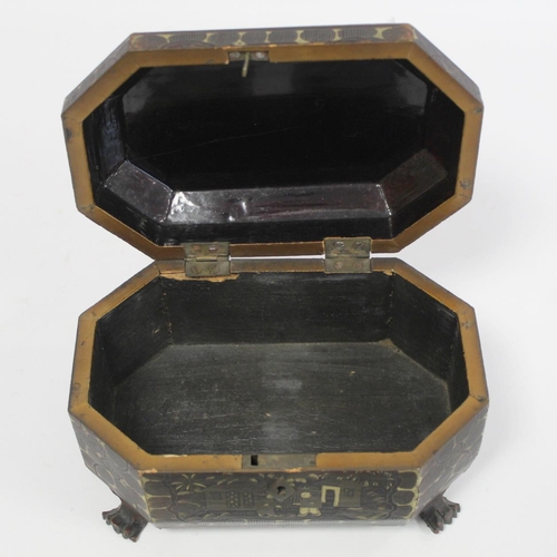 287 - 19th century Chinese black lacquer tea caddy of octagonal form with four paw feet and gilt painted p... 