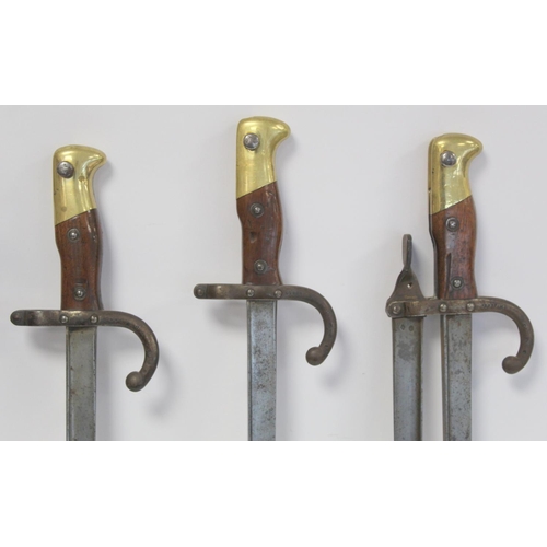 294 - Late 19th/early 20th century novelty fireside companion set made from French bayonets, each signed a... 